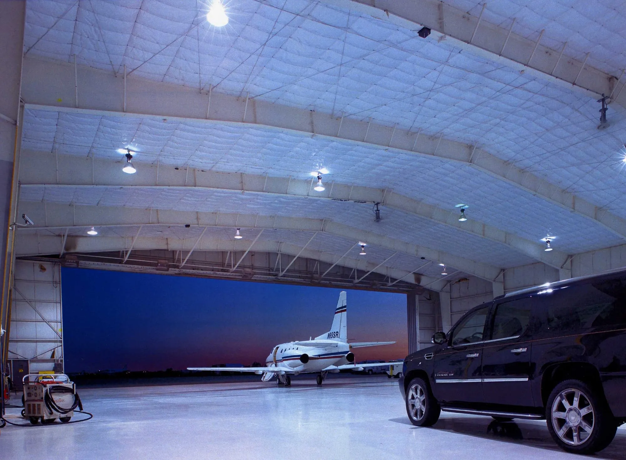 Aircraft hangar with a white insulated arched ceiling