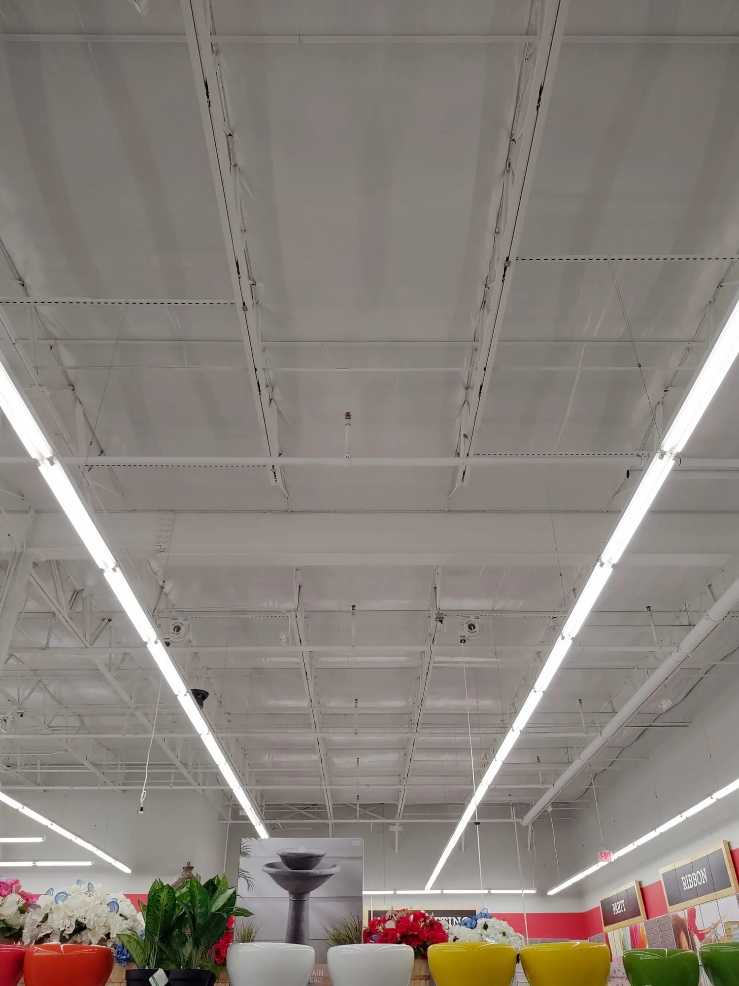 Retail store with a white insulated ceiling over the steel roof joists