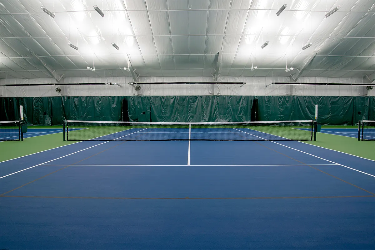 Insulated metal-building indoor tennis facility